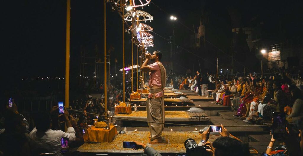 Image showcasing a vibrant scene from Varanasi, highlighting the spiritual essence of the city with devotees performing rituals at the Ghats. The photo represents a Same Day Tour in Varanasi, emphasizing the rich cultural and religious experiences of a 1 Day Tour in Varanasi. It also features glimpses of the popular Varanasi Tour Package, offering a memorable experience of the city's landmarks and traditions.