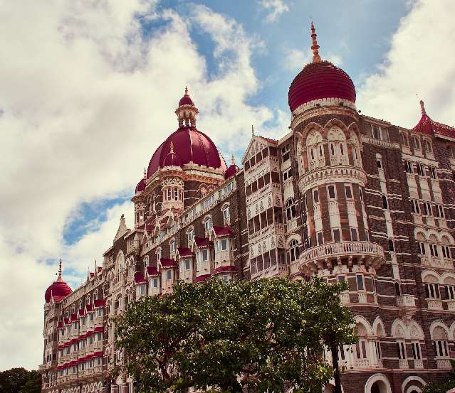 A vibrant view of Mumbai's skyline with iconic landmarks like the Gateway of India, showcasing the bustling city. Ideal for Mumbai tour packages, this image highlights the best time to visit Mumbai, offering a glimpse into the city's rich history and modern charm. Learn how to reach Mumbai and explore its historical significance through this captivating cityscape.